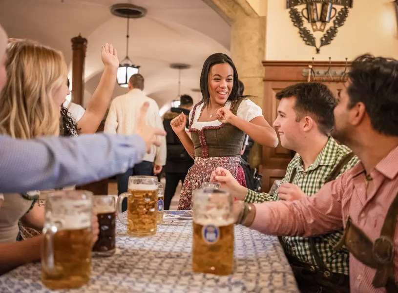 Travellers enjoying steins in a German Beer Hall in Germany