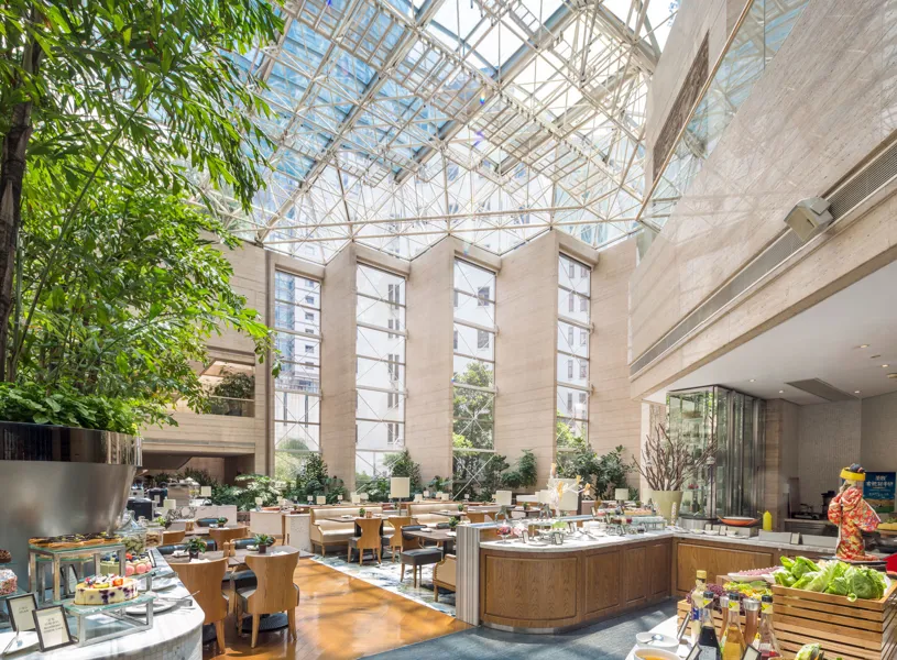 Kunlun Jing An hotel atrium buffet under glass roof, Shanghai, China
