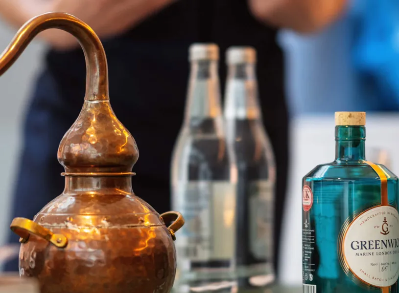 Copper still with Greenwich's gin and tonic water bottles in London