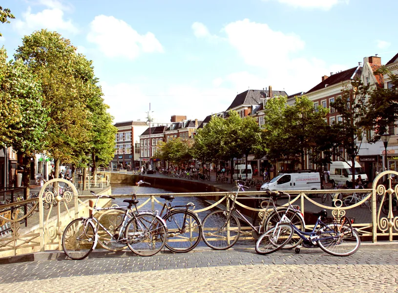 Leeuwarden canal view with decorative iron bridge, bicycles, buildings and trees