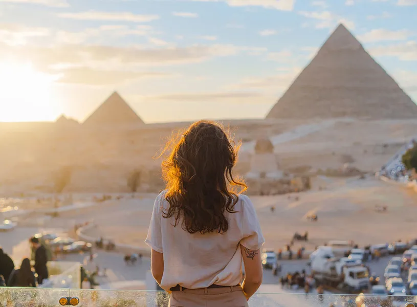 Woman Standing on Terrace Background Giza Pyramids, Giza, Egypt