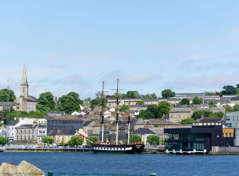 Dunbrody Famine Ship docked on River Barrow with New Ross town backdrop