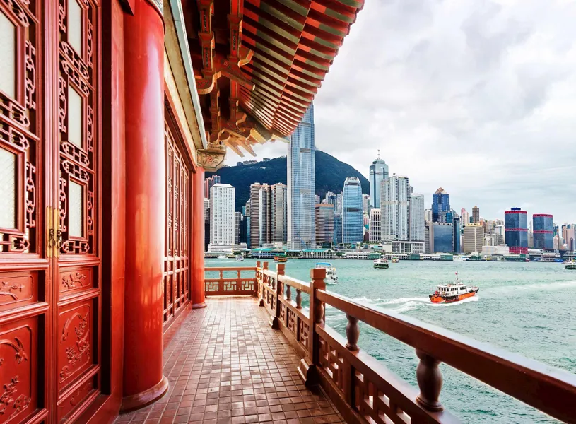 View from balcony of traditional Chinese building overlooking water and city