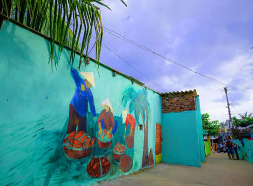  Street mural with vibrant Tam Thanh art on blue wall, Hoi An, Vietnam