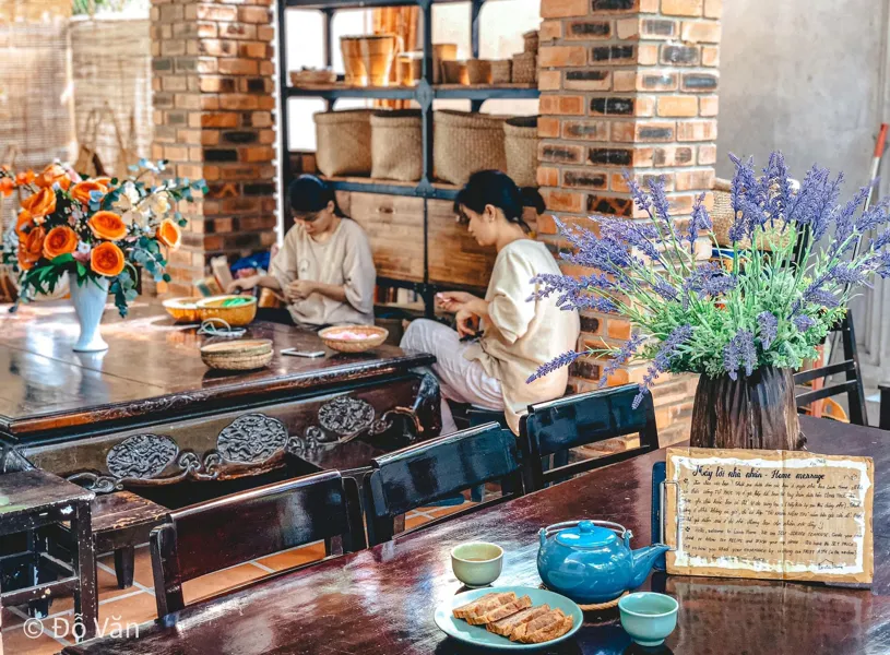 Lavin home crafts cosy cafe with wooden decor and fresh flowers, Hue, Vietnam