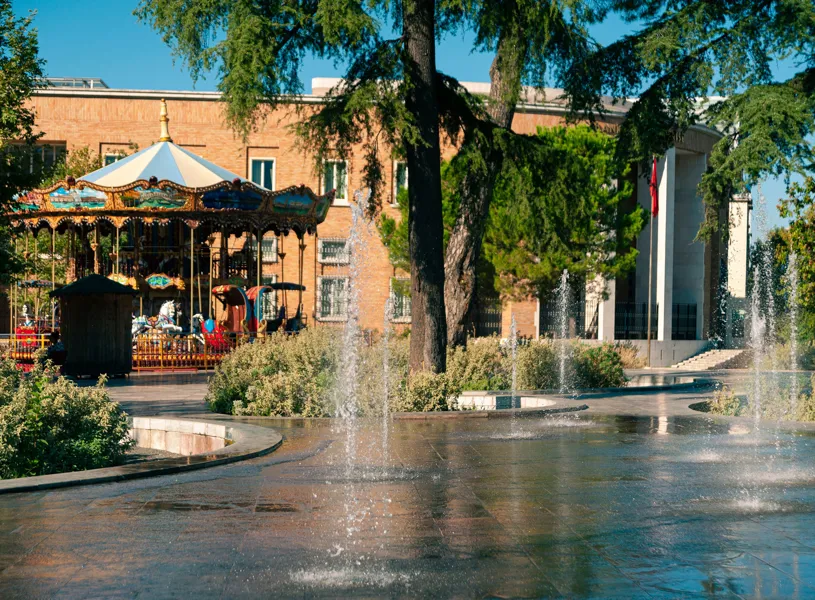 Merry go round and water fountain on Skanderbeg Square in Tirana, Albania