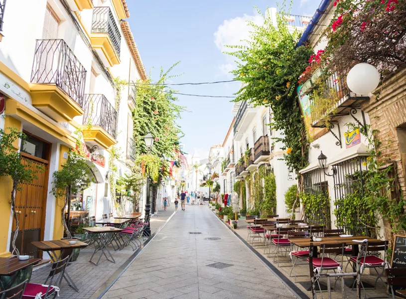 Pedestrian streets lined with outdoor cafe, balconies and greenery