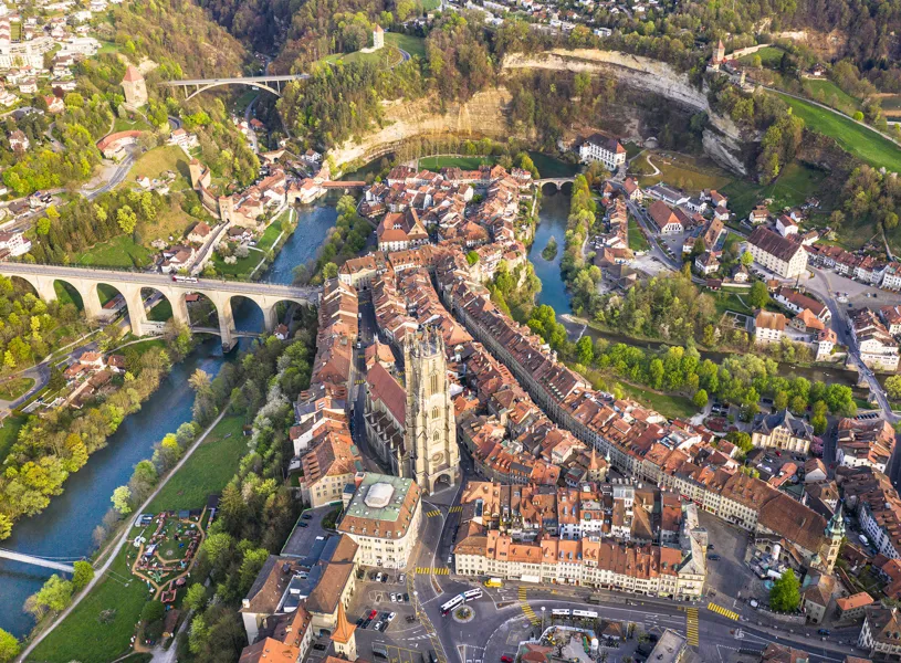 Aerial view of Fribourg old town with river and stone bridge in Switzerland