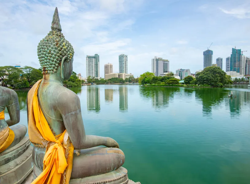 The Buddha statue with view of Colombo skyline in Colombo, Sri Lanka