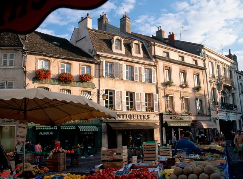 Street market with produce stalls in Beaune, France