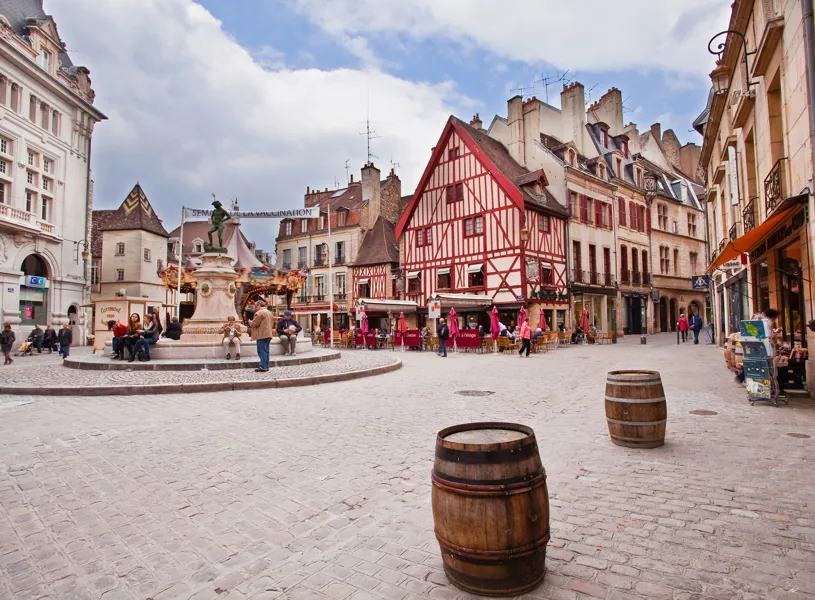 Place François Rude with statue fountain and timbered buildings in Dijon, France