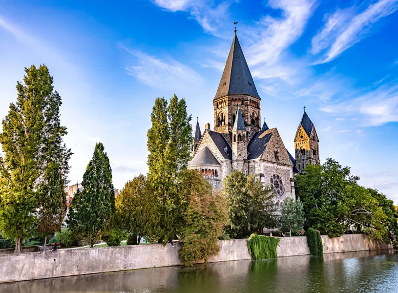 Temple Neuf beside Moselle River and trees in Metz, France