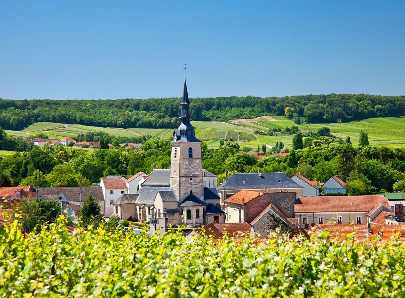 Church spire in Sermiers village with vineyards and hills in France