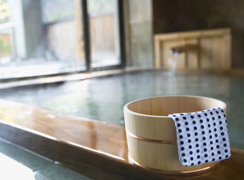 Traditional Japanese Onsens with wooden tub and tenugui towel, Hokkaido, Japan