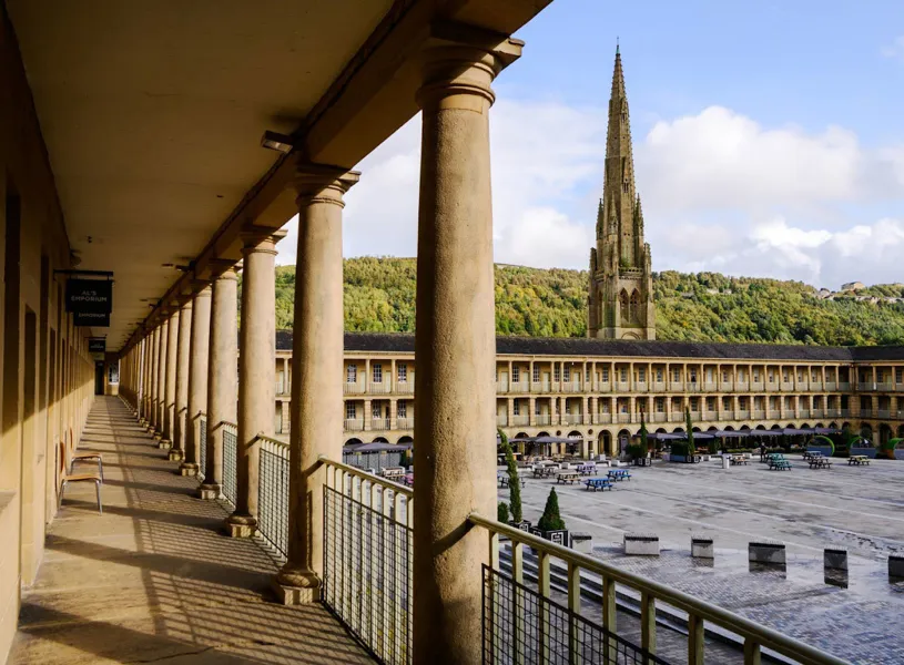 Piece Hall courtyard with colonnade and church spire in Yorkshire, England
