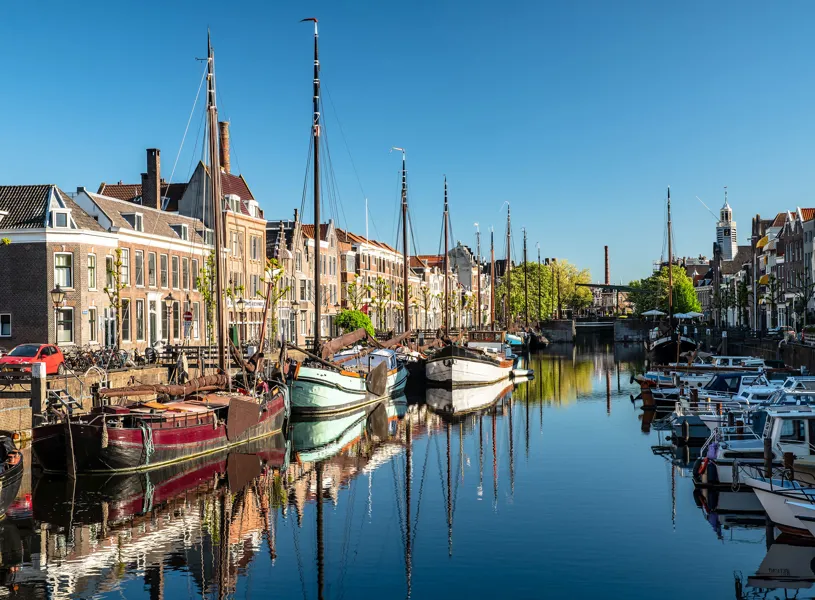 Boats docked along Delfshaven canal in Rotterdam, Netherlands