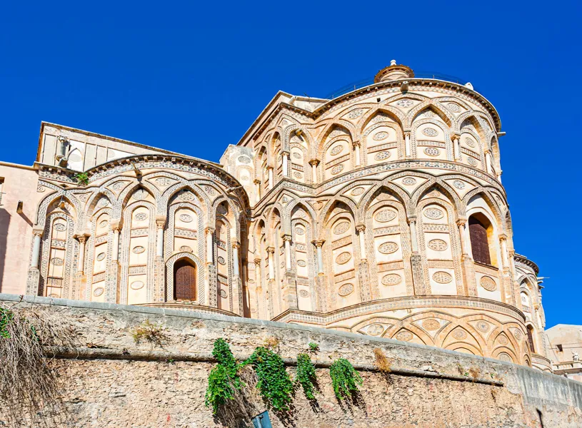 Exterior view of Cathedral of Monreale with ornate stonework in Sicily, Italy