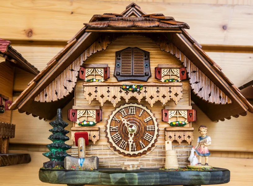 Traditional German cuckoo clock with carvings and figurines