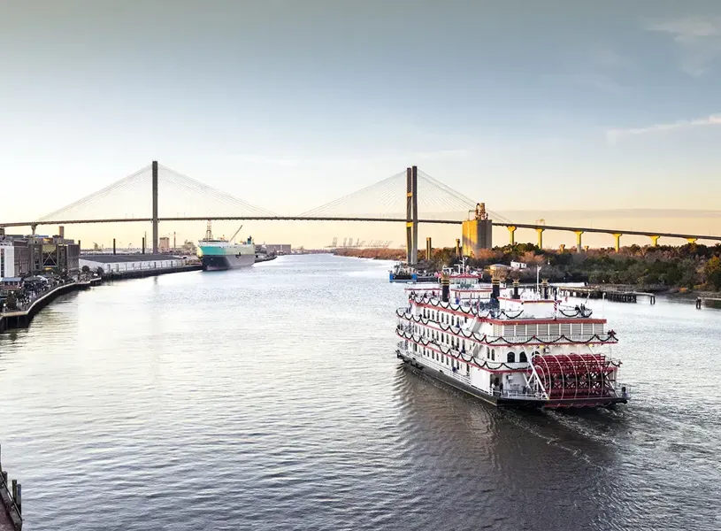 Riverboat cruising along a river in Savannah, Georgia, USA