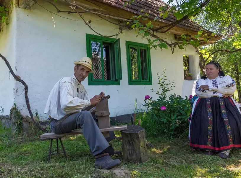 View of couple, in traditional Romanian folk costume, Muzeul Astra Ethnographic Park, Sibiu, Romania