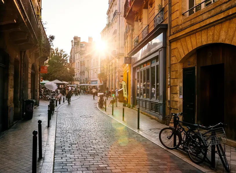 Cobbled street in Bordeaux old town lit by the sun at sunset France